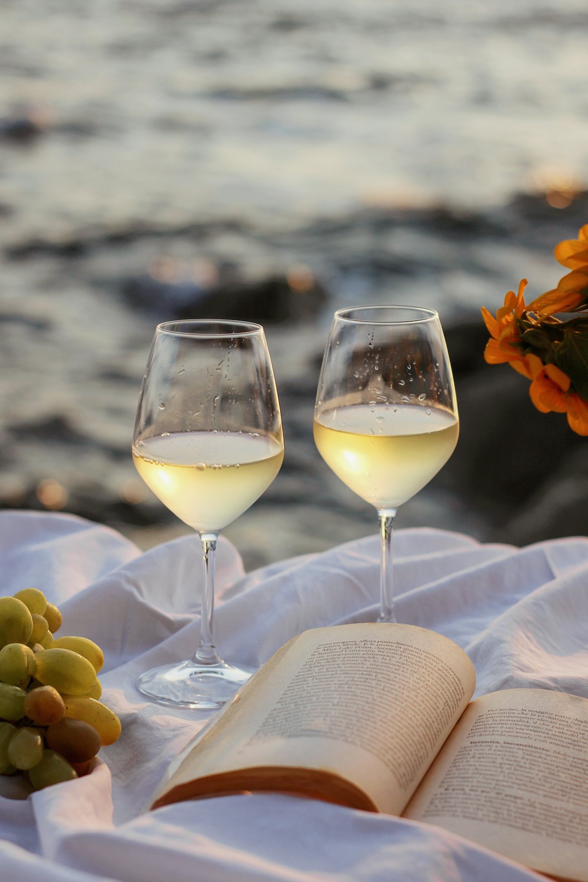 Two glasses of white wine at sunset