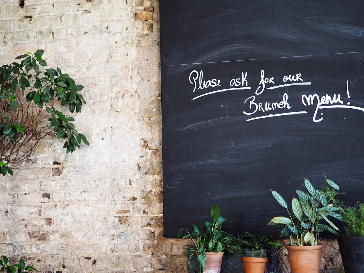A hand-written chalkboard sign in a restaurant