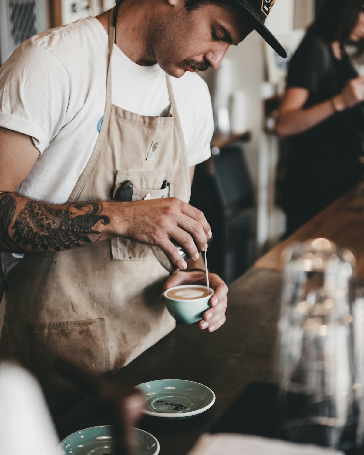 A barista preparing coffee behind the counter